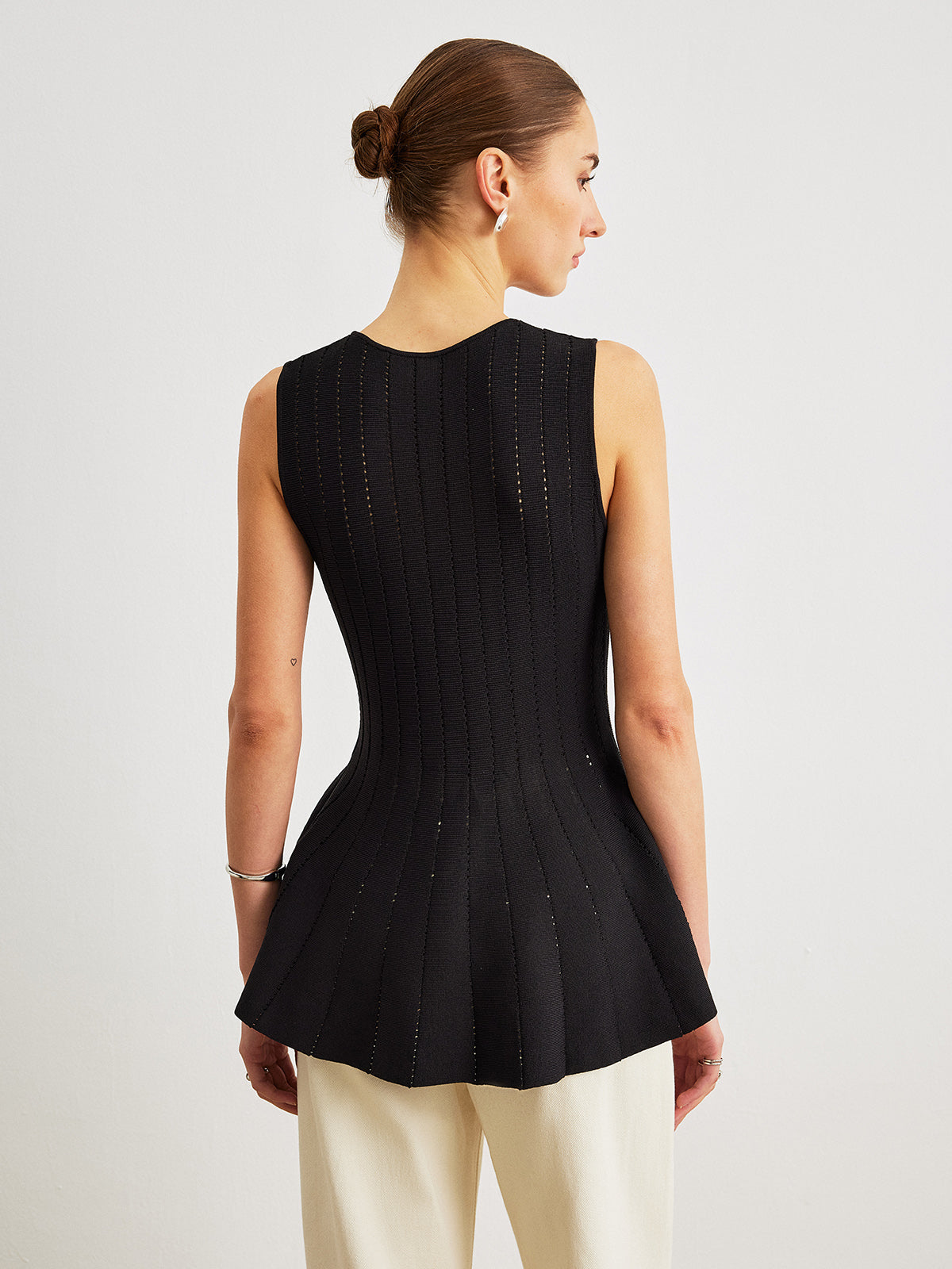 Semi-Sheer Knit Peplum Top With Bow Detail